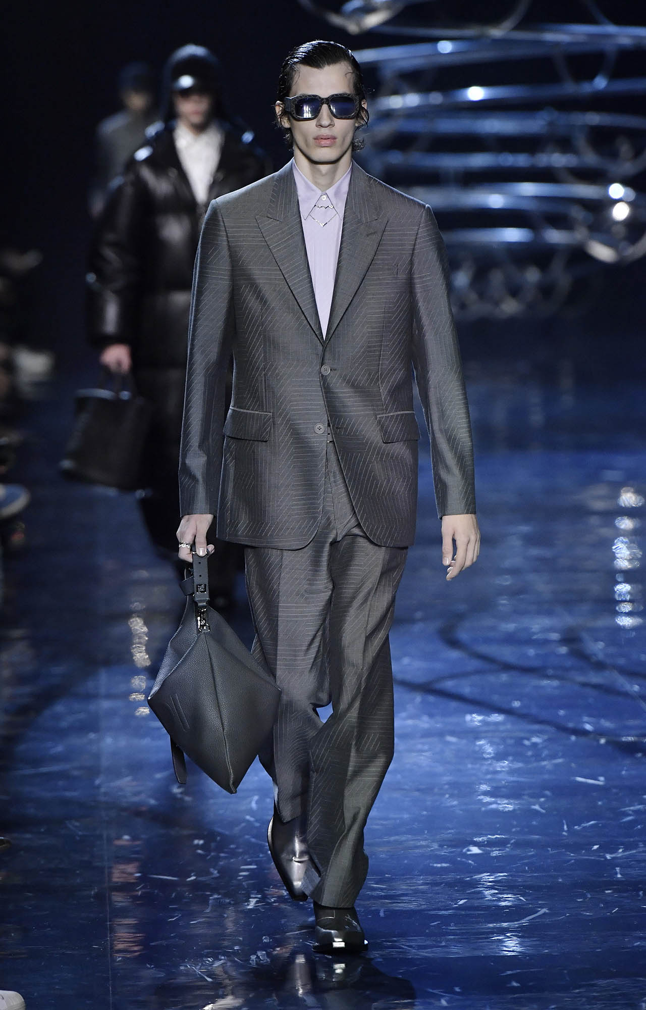 A model, sunglasses detail, walks the runway at the Fendi fashion